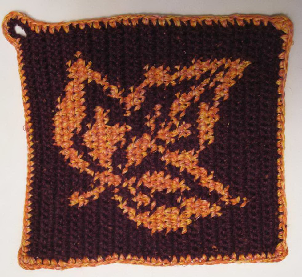 Knitted glove with orange leaf